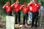 Military Men Saluting Grave with Flag